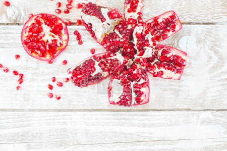 Photo for Fresh pomegranates on wooden table - Royalty Free Image
