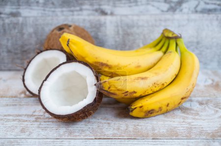 Photo for Coconut and bananas on the wood background - Royalty Free Image