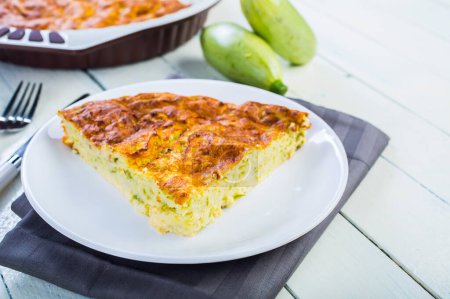 Photo for Pie with zucchini, cheese and herbs on the table - Royalty Free Image