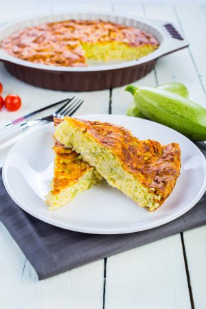 Photo for Pie with zucchini, cheese and herbs on the table - Royalty Free Image