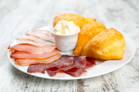 Photo for Sliced prosciutto with salami, sour cream and flat bread - Royalty Free Image