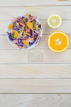 Photo for Fresh salad of autumn vegetables - purple and green cabbage, carrots, green onions. Rich vitamin vegetarian lunch - Royalty Free Image