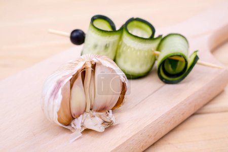 Photo for Sliced zucchini and garlic on cutting board - Royalty Free Image