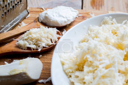 Photo for Freshly grated horseradish on wooden table - Royalty Free Image
