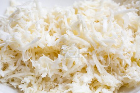 Photo for Freshly grated horseradish on wooden table - Royalty Free Image