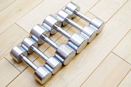 Photo for Silver dumbbells on wooden background - Royalty Free Image
