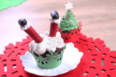 Photo for A group of cupcakes decorated with sugar Santa Claus and fir on the Christmas background. - Royalty Free Image