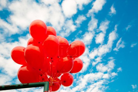 Photo for Bunch of red balloons on a blue sky - Royalty Free Image