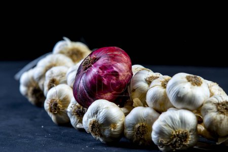 Photo for Sweet purple Crimean onions, onions and garlic on black background - Royalty Free Image