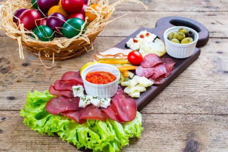 Photo for Antipasto catering platter with salami, olives and cheese on a wooden background - Royalty Free Image