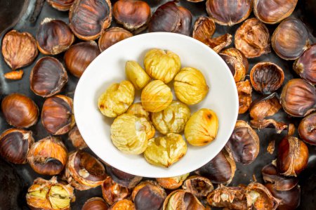 Photo for Heap of grilled edible chestnuts - Royalty Free Image