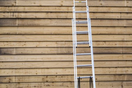 Photo for Ladder on wooden background - Royalty Free Image