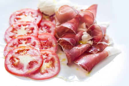 Photo for Delicious Italian cured ham with tomatoes - Royalty Free Image