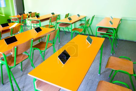 Photo for Digital tablets on the desks in classroom - Royalty Free Image