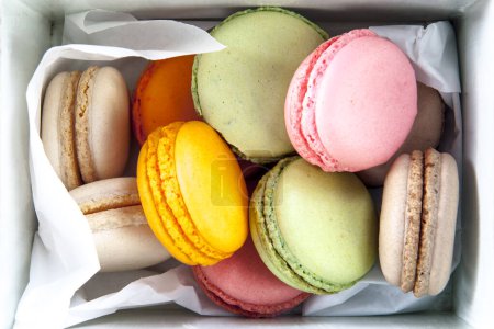 Photo for Set of different french cookies macaroons in a paper box. Top view. - Royalty Free Image