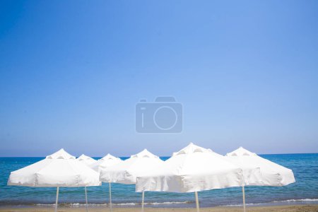 Photo for Chairs and umbrellas on sand beach - Royalty Free Image
