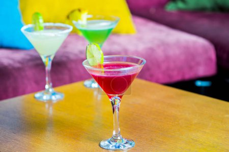 Photo for Colorful cocktail drinks in glasses on table - Royalty Free Image