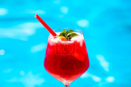 Photo for Cold red cocktail near the swimming pool - Royalty Free Image