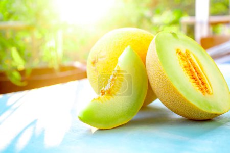 Photo for Fresh sweet green melons on the wooden table - Royalty Free Image
