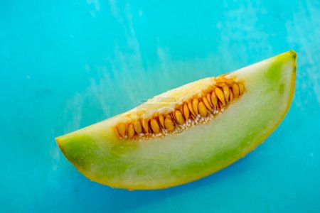 Photo for Fresh sweet green melon on the wooden table - Royalty Free Image