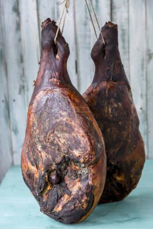 Photo for Jamon serrano. Traditional ham on turquoise background - Royalty Free Image