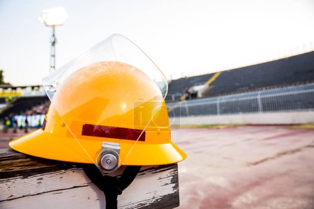 Photo for Safety helmet on empty stadium - Royalty Free Image