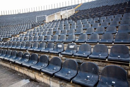 Photo for Empty tribunes with seats on soccer stadium - Royalty Free Image