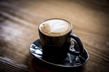 Photo for Cup of coffee on wooden table - Royalty Free Image