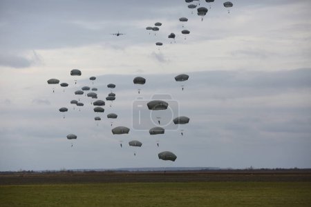 Photo for Lots of parachutists in the cloudy sky - Royalty Free Image