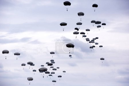 Photo for Lots of parachutists in the cloudy sky - Royalty Free Image