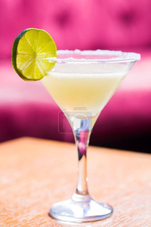 Photo for Yellow coctail with lime, margarita cocktail with salty rim - Royalty Free Image