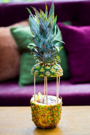 Photo for Tropical cocktail in pineapple on table - Royalty Free Image