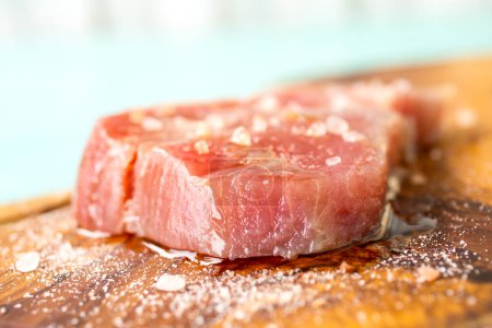 Photo for A fresh piece of tuna on a wooden board - Royalty Free Image