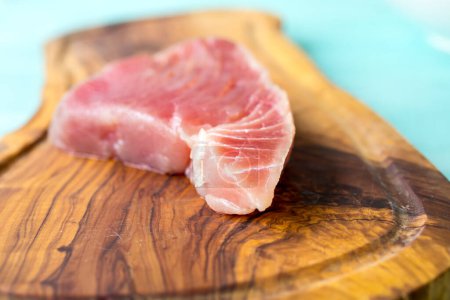 Photo for A fresh piece of tuna on a wooden board - Royalty Free Image