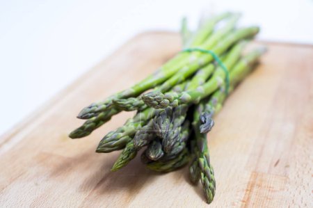 Photo for Close up of asparagus on wooden board - Royalty Free Image