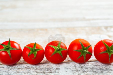 Téléchargez les photos : Rangée de tomates sur fond bois - en image libre de droit