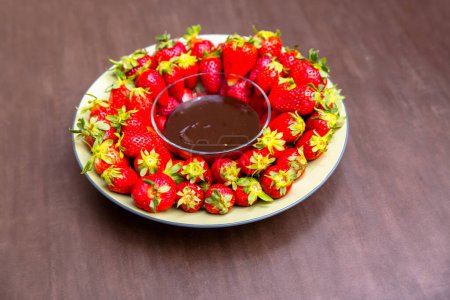 Photo for Strawberries and chocolate on white plate - Royalty Free Image