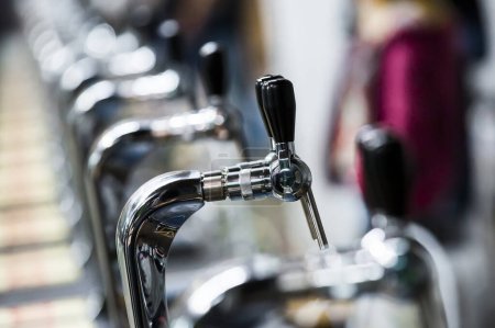 Photo for Beer pipes in blurred bar - Royalty Free Image