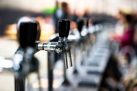 Photo for Beer pipes in blurred bar - Royalty Free Image