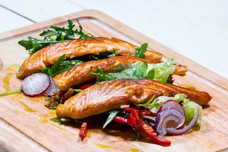 Photo for Fried salmon with vegetables on wooden board - Royalty Free Image
