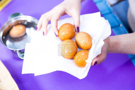 Photo for Woman hand holding napkin with eggs - Royalty Free Image