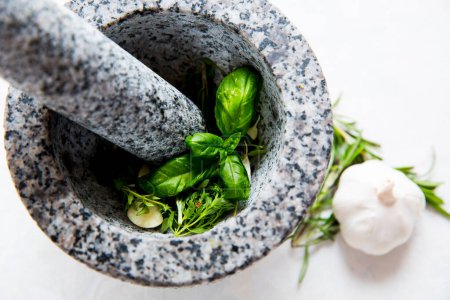 Photo for Basil and garlic in a mortar - Royalty Free Image