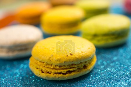 Photo for Cake macarons or macaroons on blue background from above, colorful almond cookies, pastel colors - Royalty Free Image