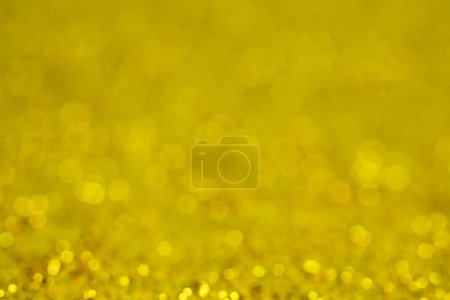 Photo for Christmas gold background. Golden holiday glowing backdrop. Defocused Background With Blinking Stars. Blurred Bokeh - Royalty Free Image