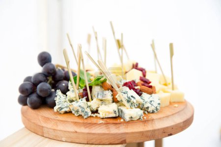 Photo for Platter of assorted cheeses and fruits from above - Royalty Free Image