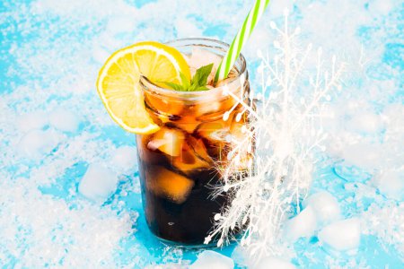 Photo for Summer drink with ice and lemon on blue background - Royalty Free Image