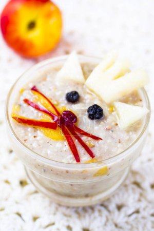 Photo for Oatmeal porridge with berries in jar - Royalty Free Image