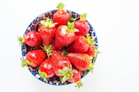 Photo for Fresh strawberries in a bowl on white - Royalty Free Image