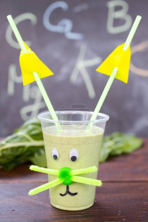 Photo for Childish green smoothie in cup - Royalty Free Image