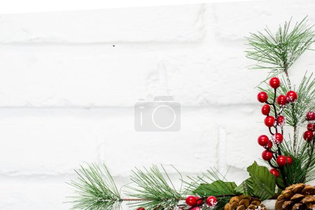 Photo for Christmas decoration of mistletoe, holly with berries, ivy and pine cones - Royalty Free Image